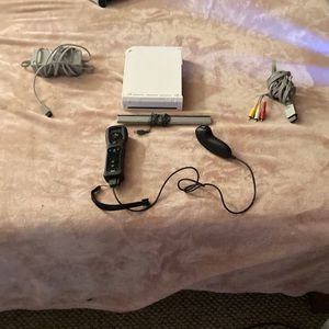 Wiii gaming console comes with controller and cables needed for setup.